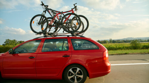 Car Is Transporting Bicycles On The Roof. Bikes On The Trunk